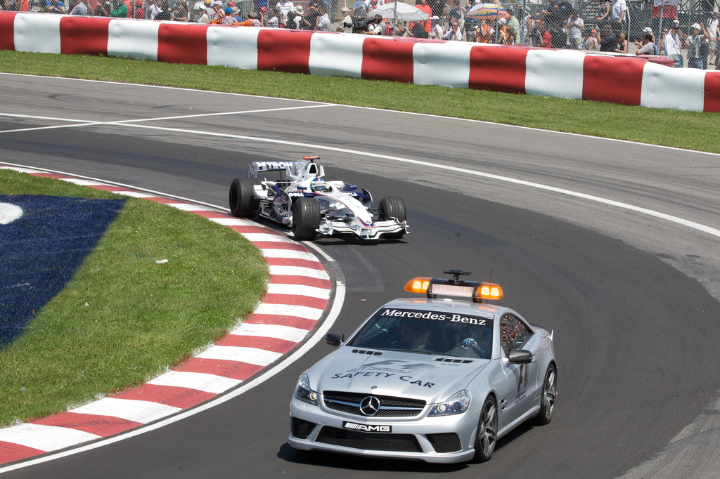 Nick Heidfeld follows the safety car FIA Formula One Race Director 